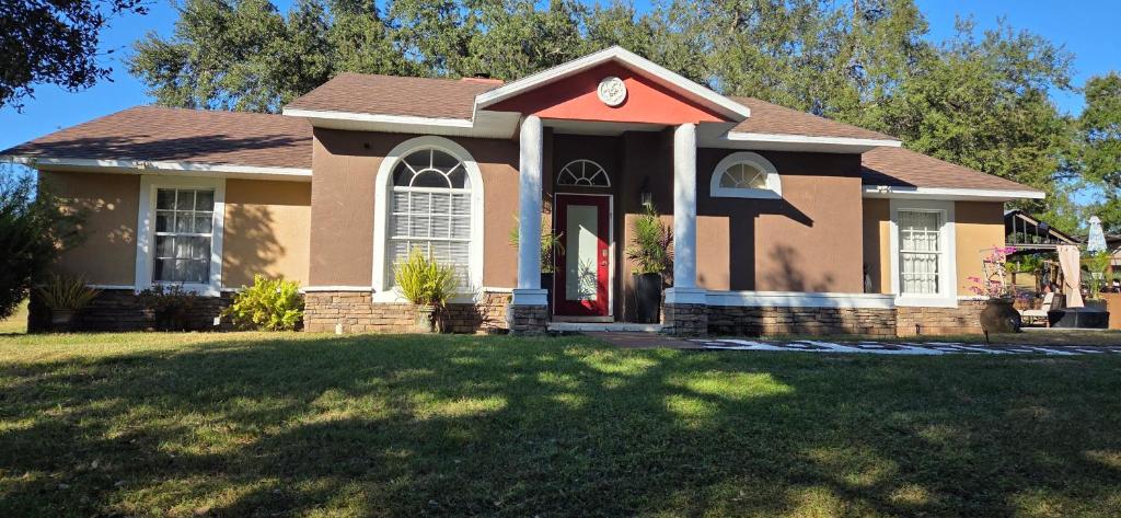 a small house with a lawn in front of it at Serene Mountain Retreat With Pool in Clermont