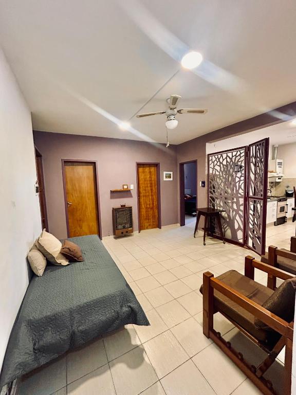 a bedroom with a bed and a living room at Espacio Planetaria in Córdoba