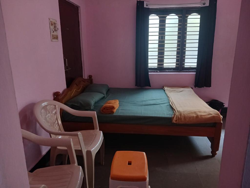 a small bedroom with a small bed and a window at GARDEN villa, Vanasthalipuram in Hyderabad