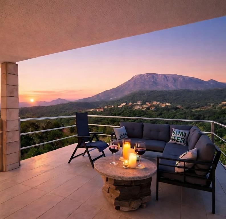 a patio with a couch and a table with wine glasses at Villa Sea La Vie in Utjeha