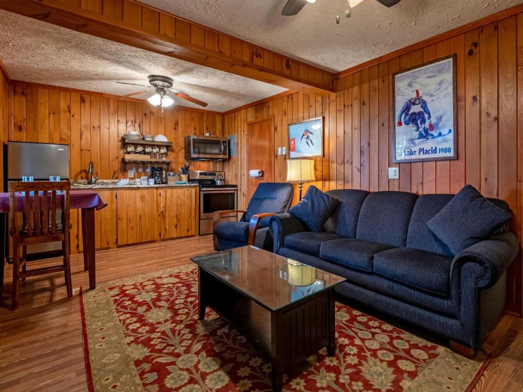 a living room with a blue couch and a table at Stemwinder 6B 1 Bedroom, 1 Full Bath, Slope Side in Slaty Fork