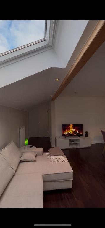 a bedroom with a large white bed and a tv at Ferienwohnung Brönnleins in Koblenz
