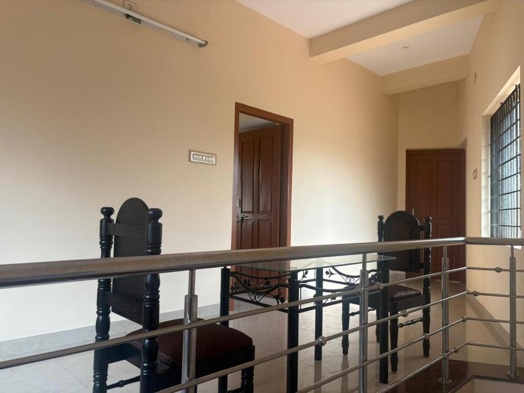 a view of a room with a balcony at SM Cottage in Mangalore