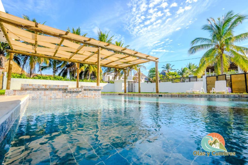 a pool with a pergola and palm trees at Villa Moka 2 in Taxisco