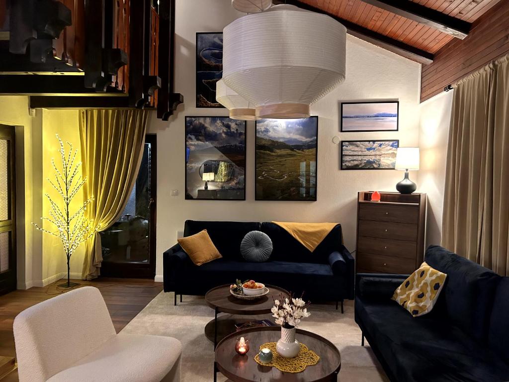 a living room with a blue couch and a table at Wellness house Svjetlost in Jahorina