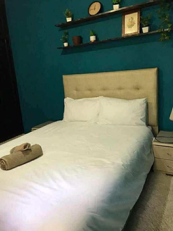 a large white bed with a pillow on top of it at Sweet appartement in Tangier