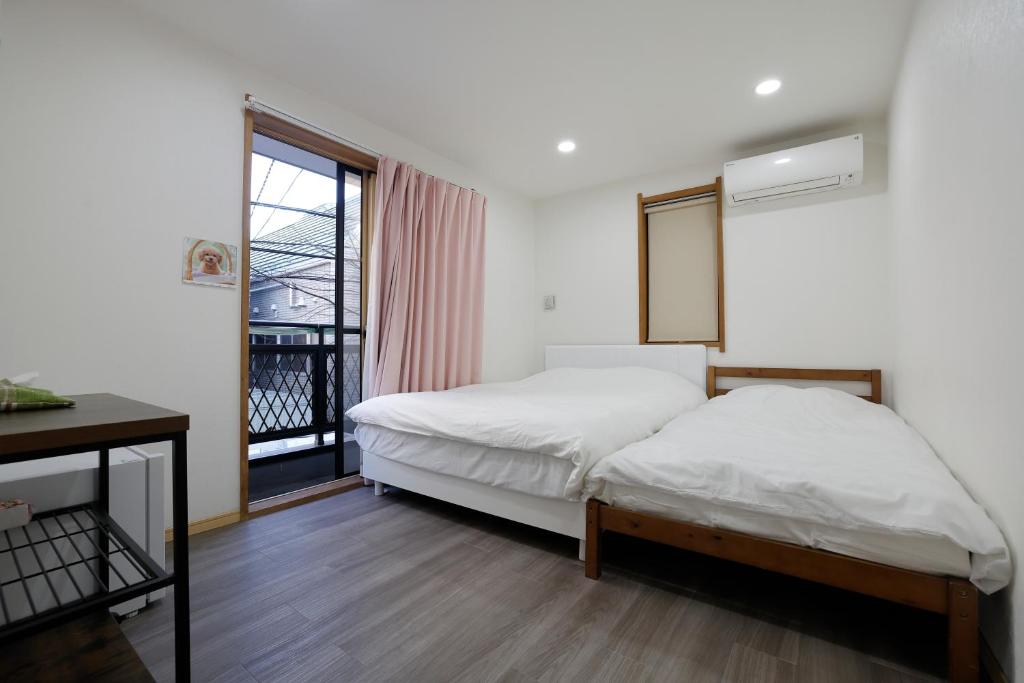 a bedroom with a bed and a window at Tokyo My Home Private Room for 3 Guests near Shinjuku Shared Facilities in Tokyo