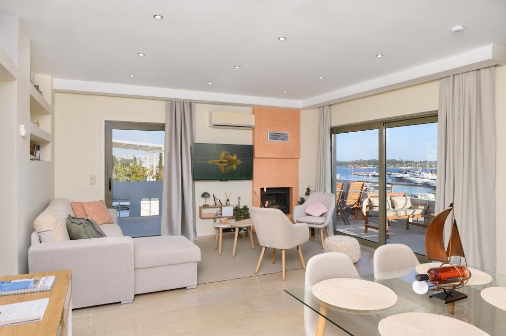 a living room with a couch and a table at Glyfada Cove Apartments-Ostria in Athens