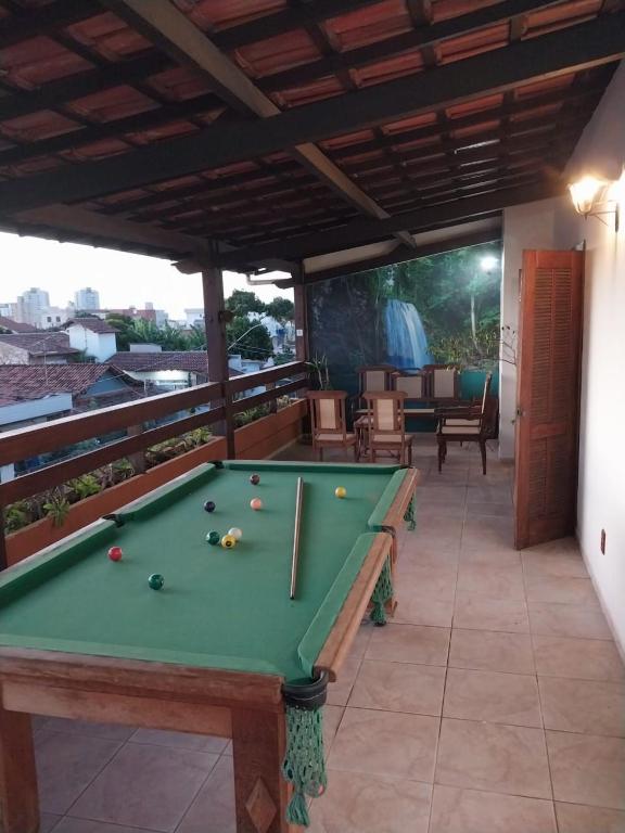 a pool table on the balcony of a house at Casa charmosa com vista e lazer in Belo Horizonte