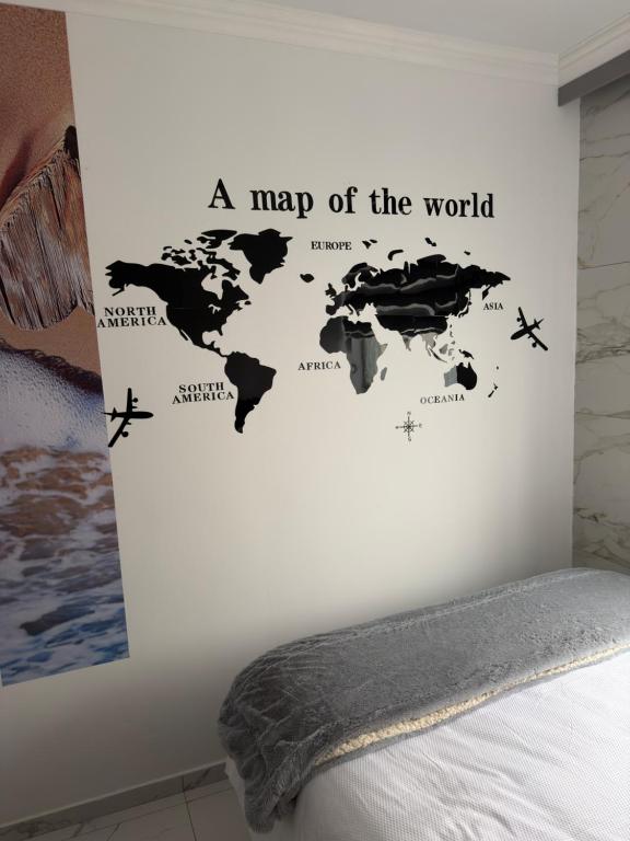 a map of the world wall sticker in a bedroom at Flowsort Grand Apartments 2 in Durban
