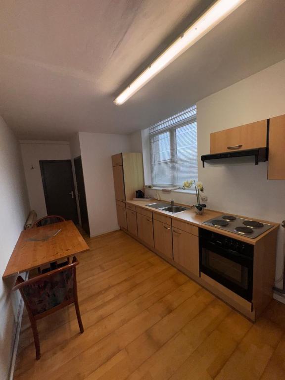 a kitchen with a table and a stove top oven at Chez Marloie in Marche-en-Famenne