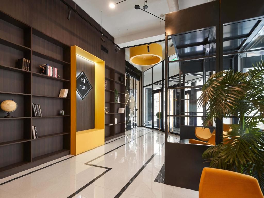 an office lobby with a yellow and black wall at Cozy Duo Loft Studio in Tartu
