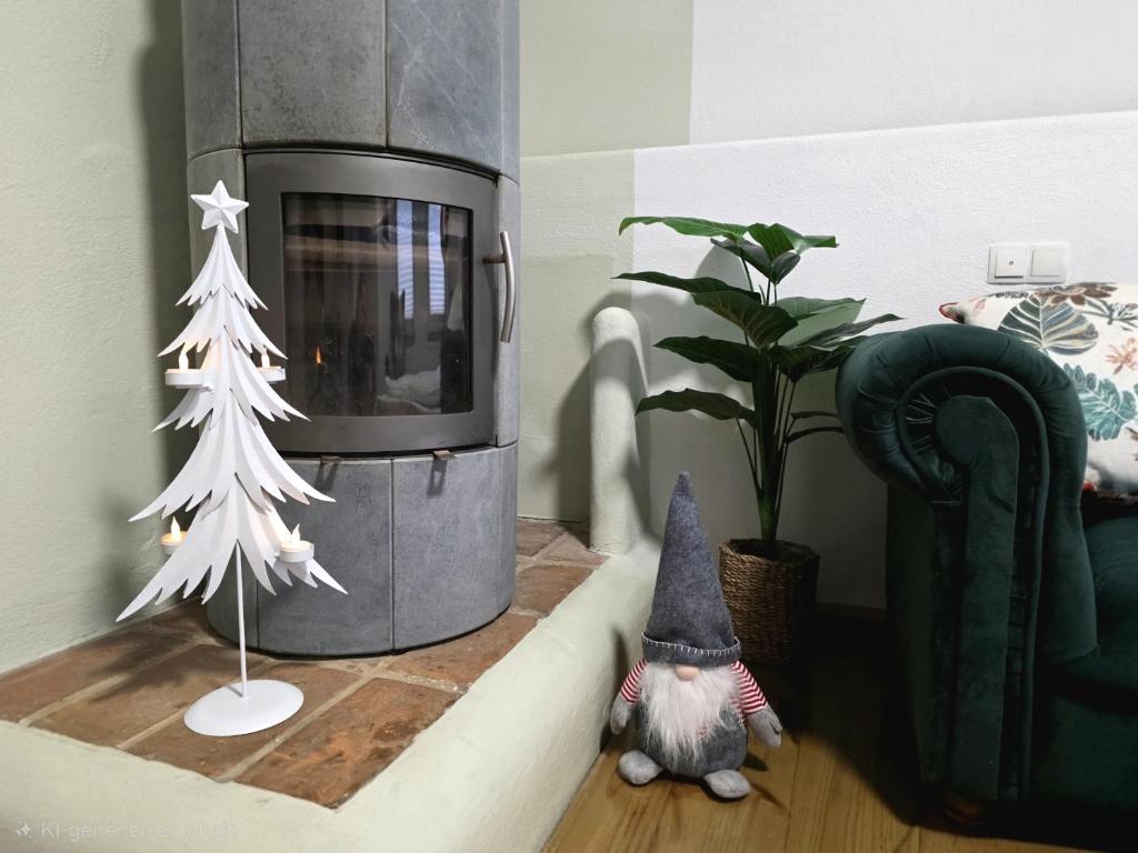 a room with a christmas tree next to a fireplace at Rost Apartments - Laufen in Laufen