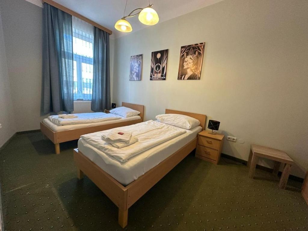 a bedroom with two beds and a window at Mariazellerhof Suite 016 in Sankt Pölten