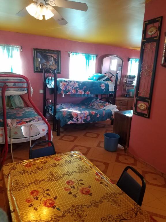 a room with two bunk beds and a living room at Hospedaje Barato Mi Casita de Colores in Tijuana