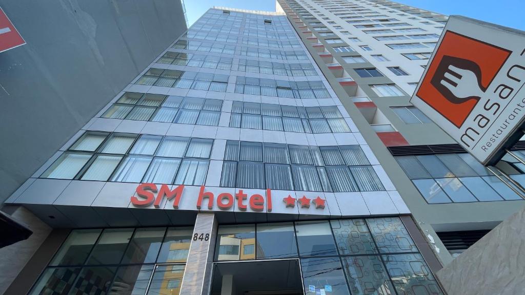 a tall building with a sign on the side of it at SM HOTEL Plus in Lima