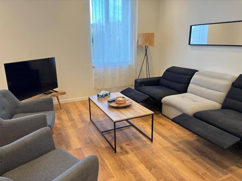a living room with couches and a coffee table at Ranteil in Albi