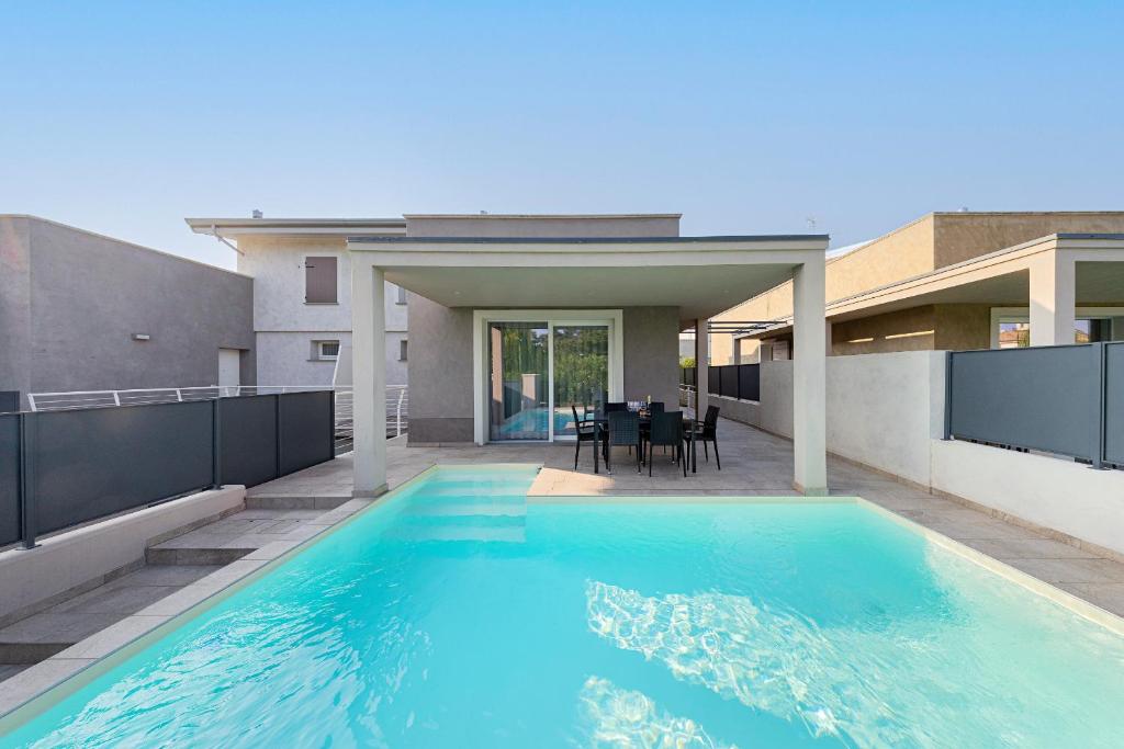 a swimming pool in the backyard of a house at Villa Prestige in Sirmione
