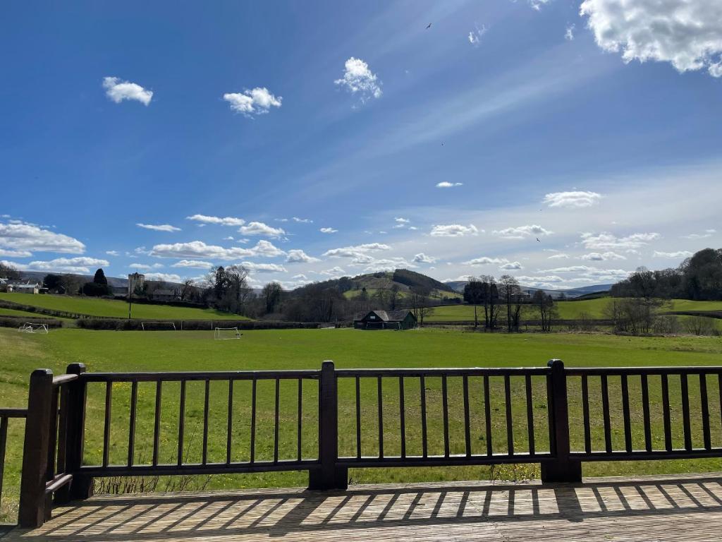a park bench with a view of a field at Swn yr Coed in Sennybridge