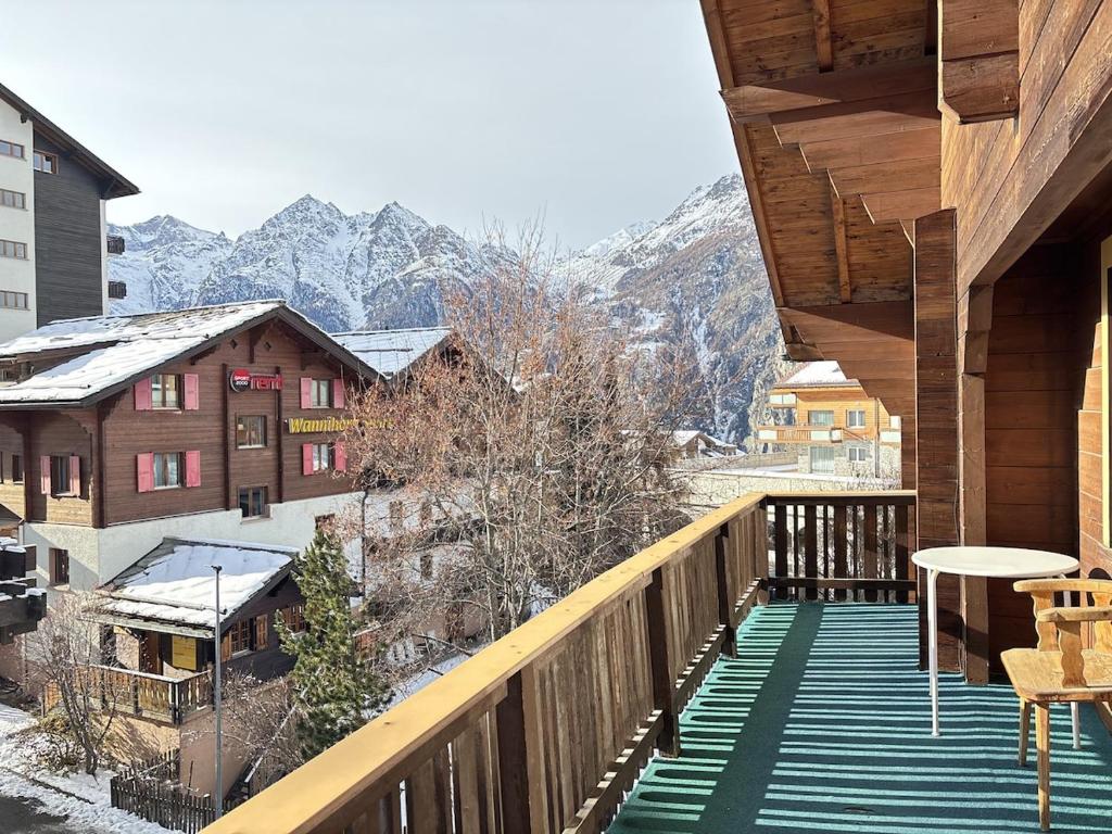 a balcony with a view of a snow covered mountain at Easy Central Stay with Parking in Grächen