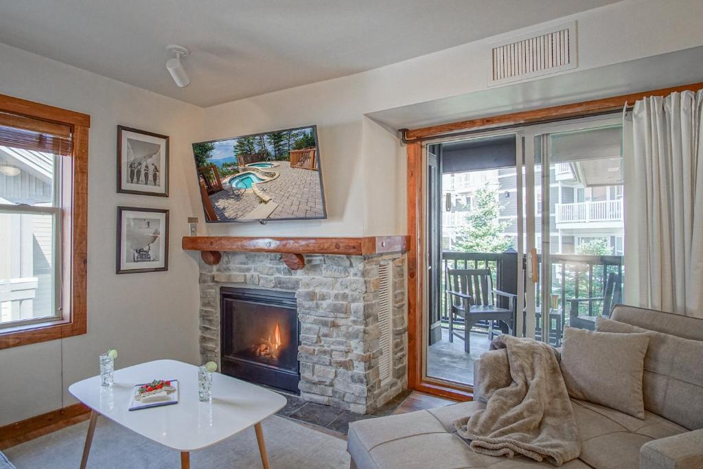a living room with a fireplace and a couch at Rimfire 342: Memory Maker, Walk to Shops, Slope Side in Slaty Fork