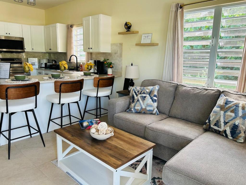 a living room with a couch and a table at O L S Property in Saint Marks Village