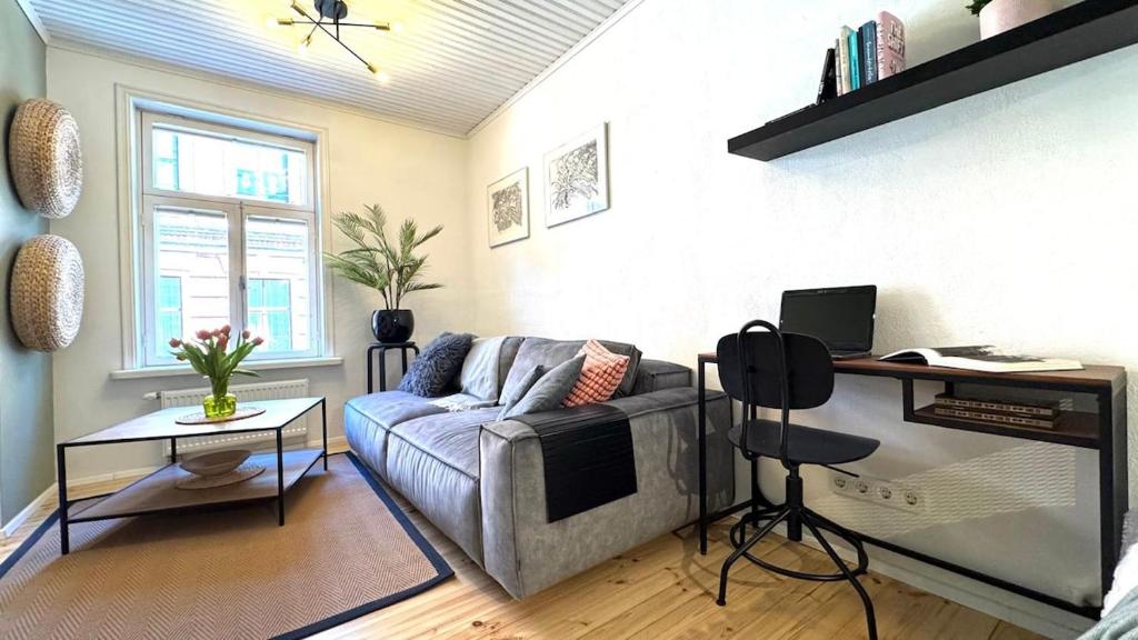 a living room with a couch and a television at Bohemian Chic apartment in Kalamaja in Tallinn