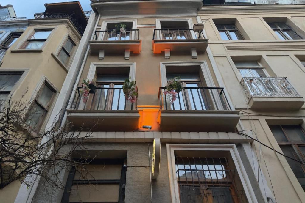 a tall building with balconies and plants on it at BeyPort Hotel Istanbul in Istanbul
