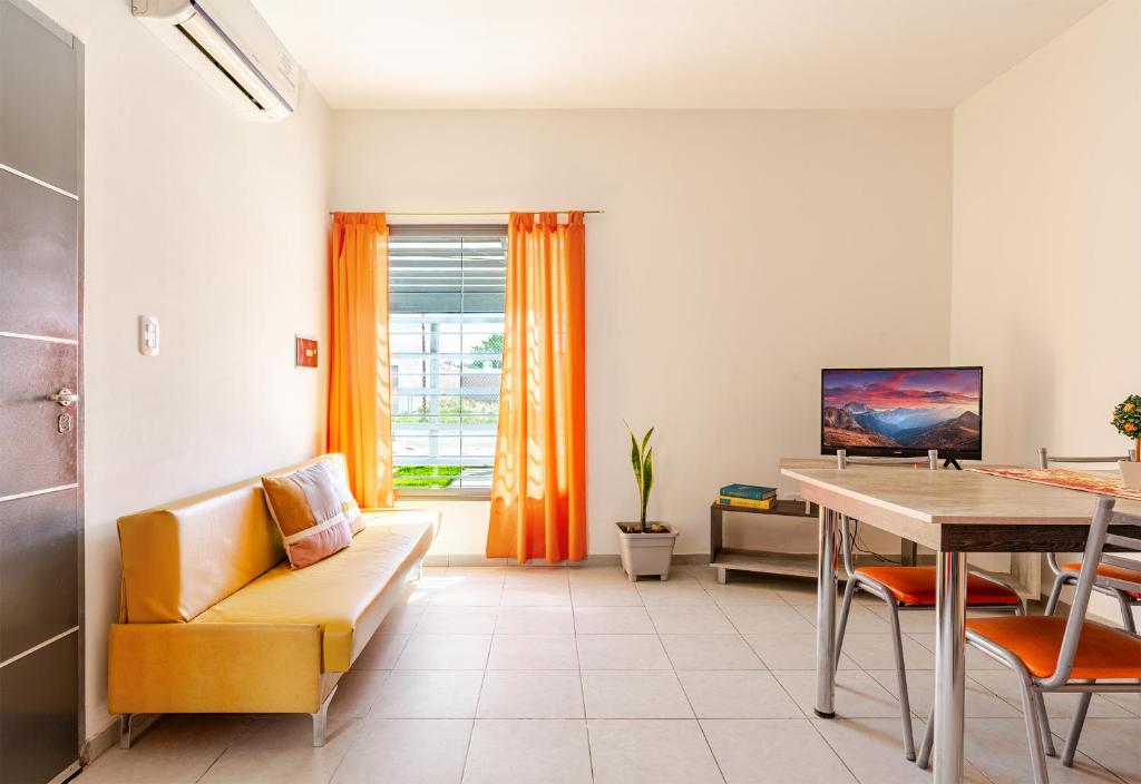 a living room with a couch and a table at Departamentos Brown -WiFi 100 MB - Cochera - Parrilla - Aire - TV Cable in San Rafael