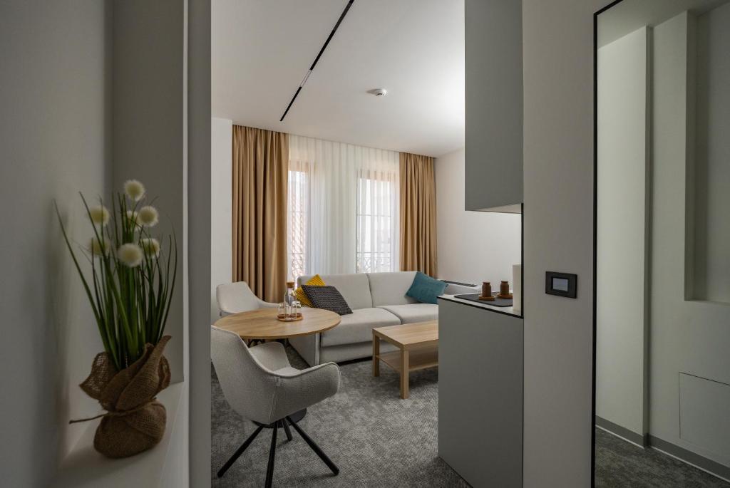 a living room with a couch and a table at Hotel Opal Casa in Novi Pazar