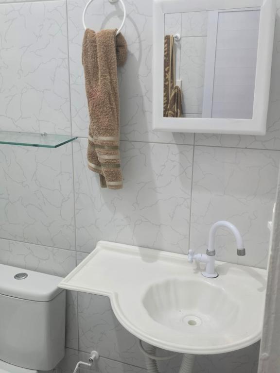 a bathroom with a sink and a toilet and a mirror at Casa Maúna in Prea