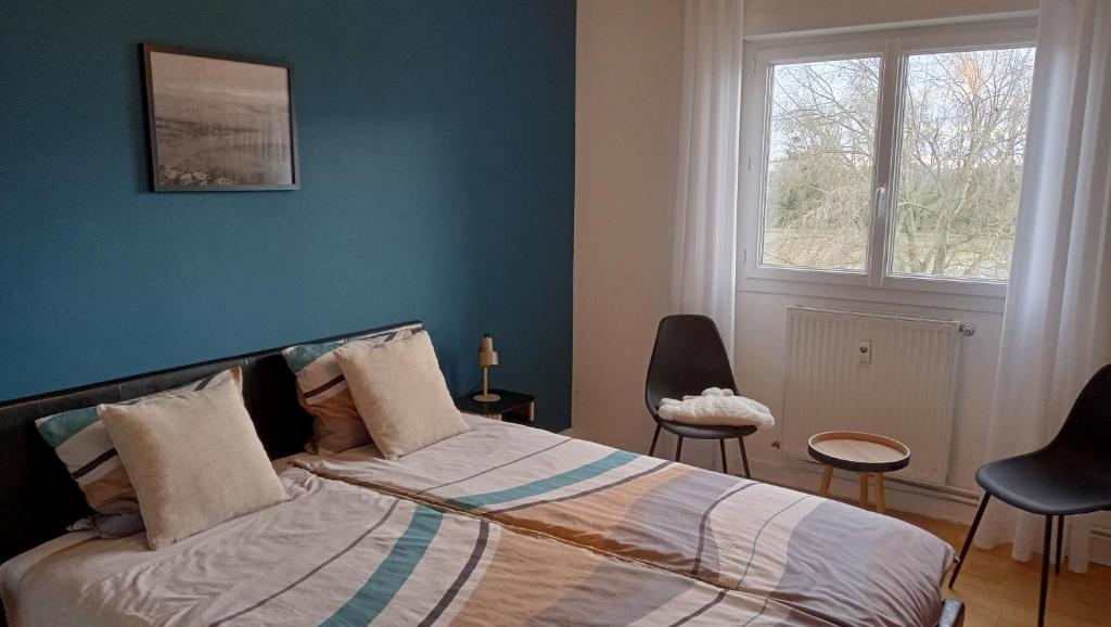 En eller flere senge i et værelse på Le Petit Mouton