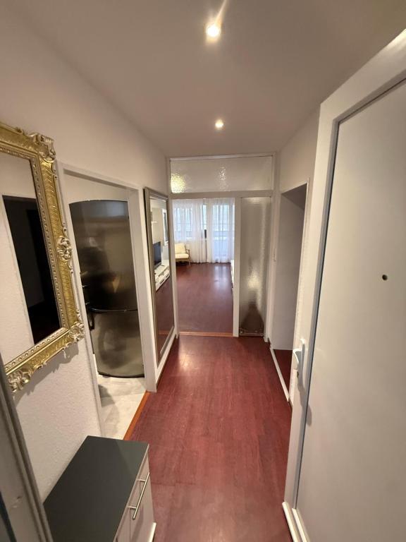 a room with a hallway with a mirror and a living room at Ferienwohnung-Montagewohnung 4 in Paderborn