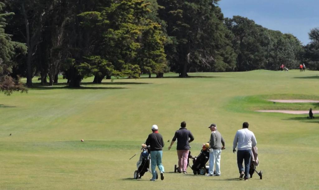 un gruppo di persone che camminano su un campo da golf di Camote Casa de Mar Tinys House a La Estafeta