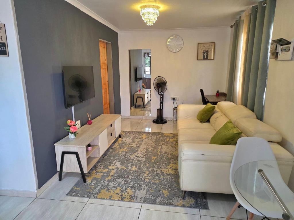 a living room with a couch and a table at One Bedroom Apartment B in Kempton Park
