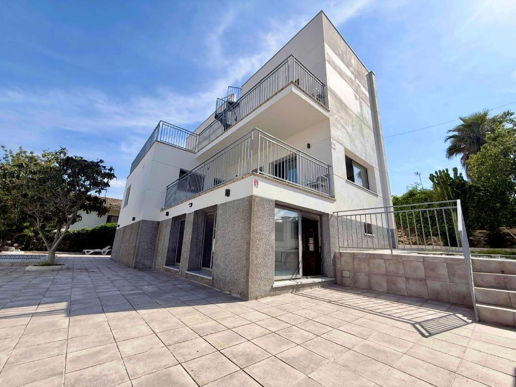 a large building with a balcony on top of it at The White House in Calafell