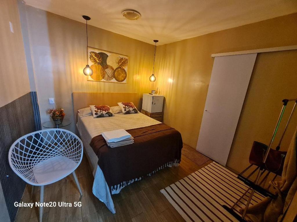 a small bedroom with a bed and a chair at THEHotelBoutiqueCidadeVelha in Belém