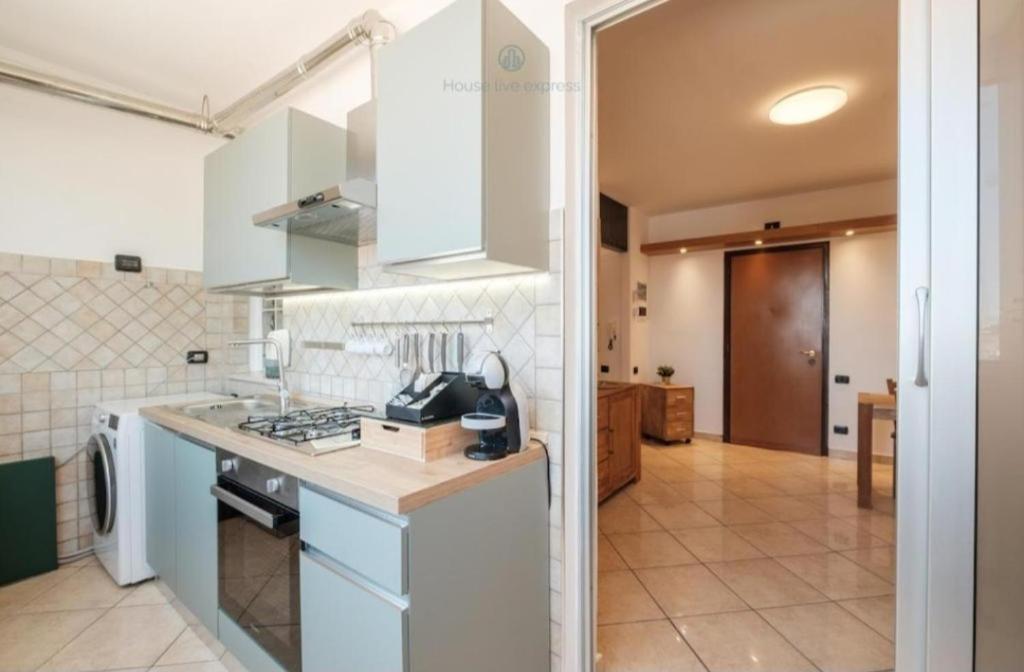 a kitchen with white cabinets and a counter top at Dimora Karalis in Cagliari