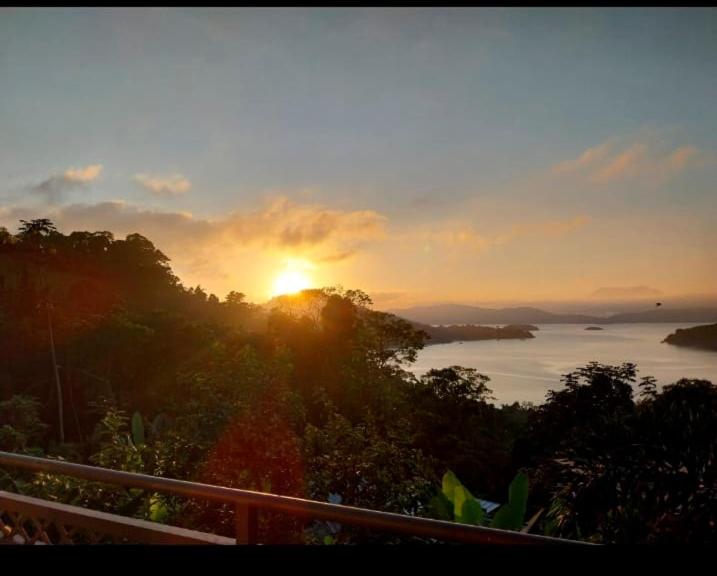 a sunset over a body of water with the sun setting at Varanda do Céu Paraty in Paraty
