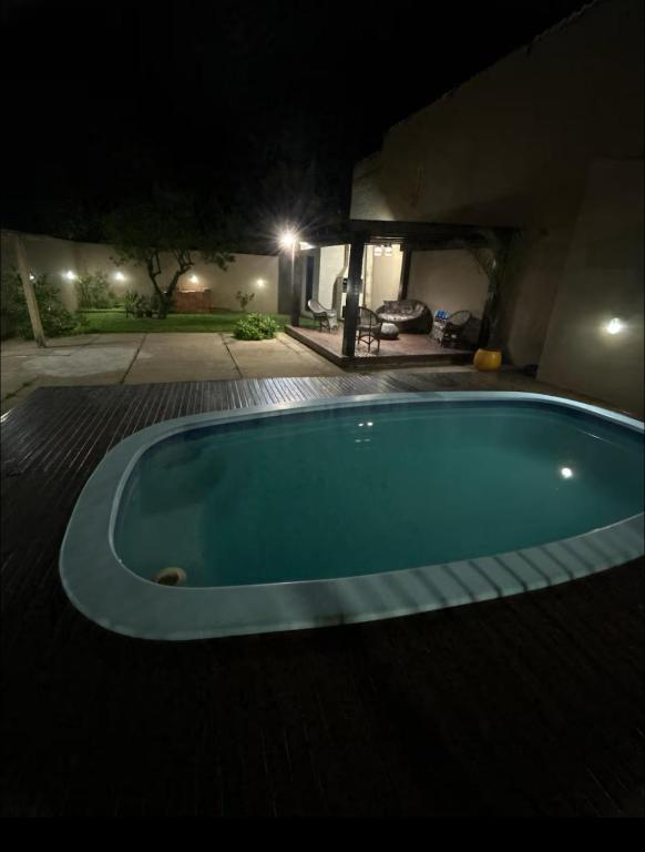 a large swimming pool in a yard at night at Espaço para Hermanos in São Gabriel