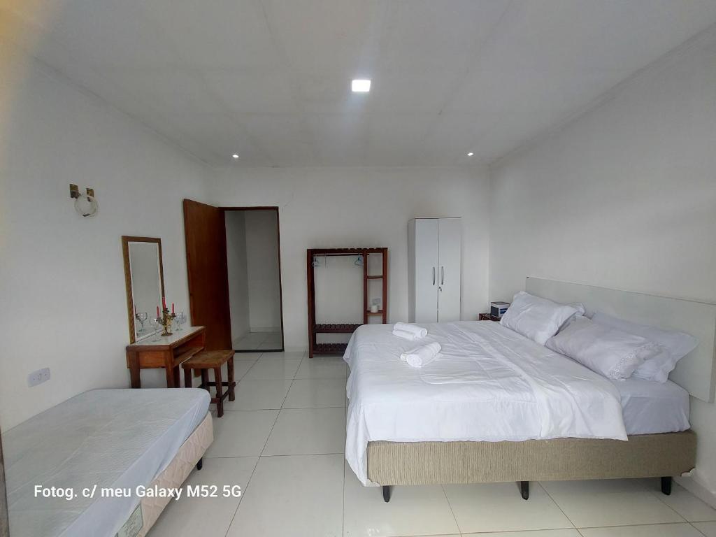 En eller flere senge i et værelse på Residencial Maria de Lourdes