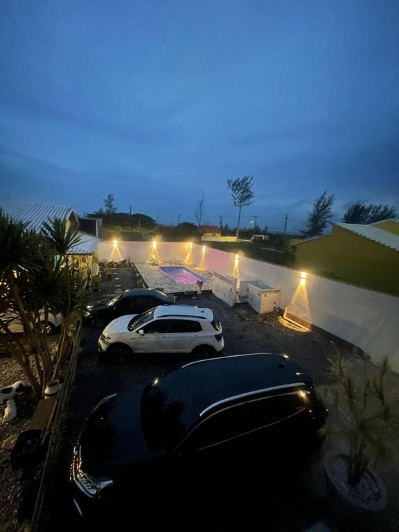 a group of cars parked in a parking lot at night at Pousada Morada dos Guarás in Ilha Comprida