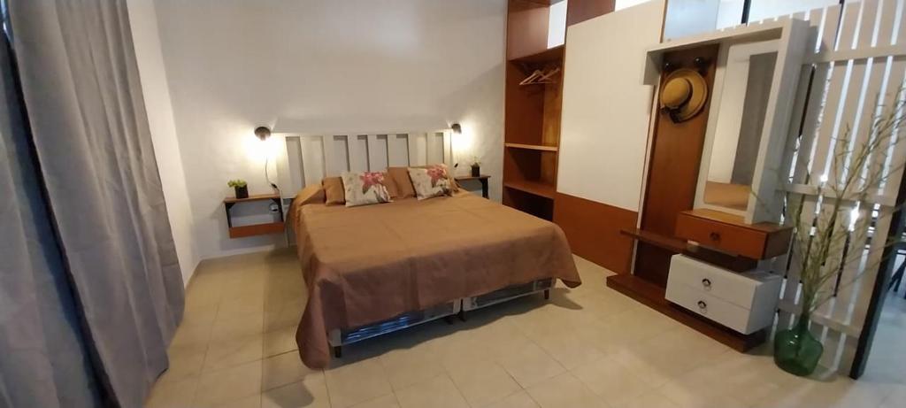 a bedroom with a bed and a mirror at La Casita de Oreste in Cosquín