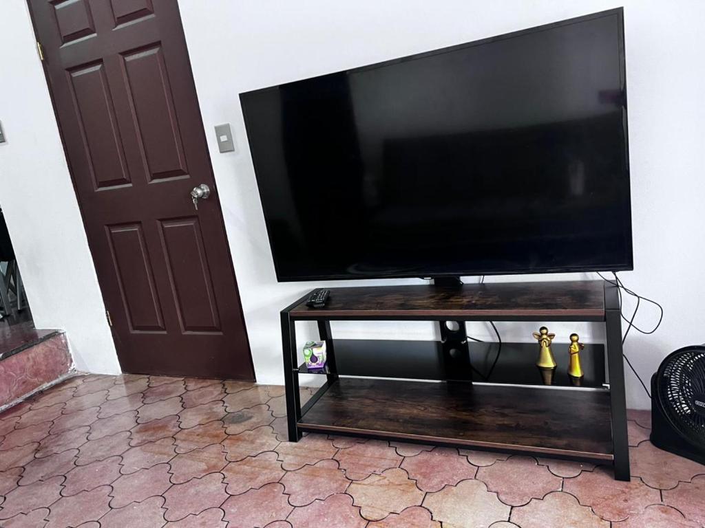 a flat screen tv sitting on a wooden table at Casa Girasol PZ in San Isidro