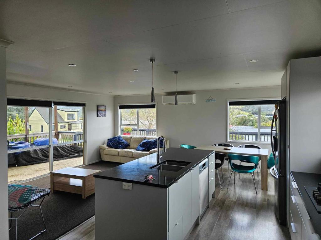a kitchen and living room with a counter top at Podgsters in Mangonui