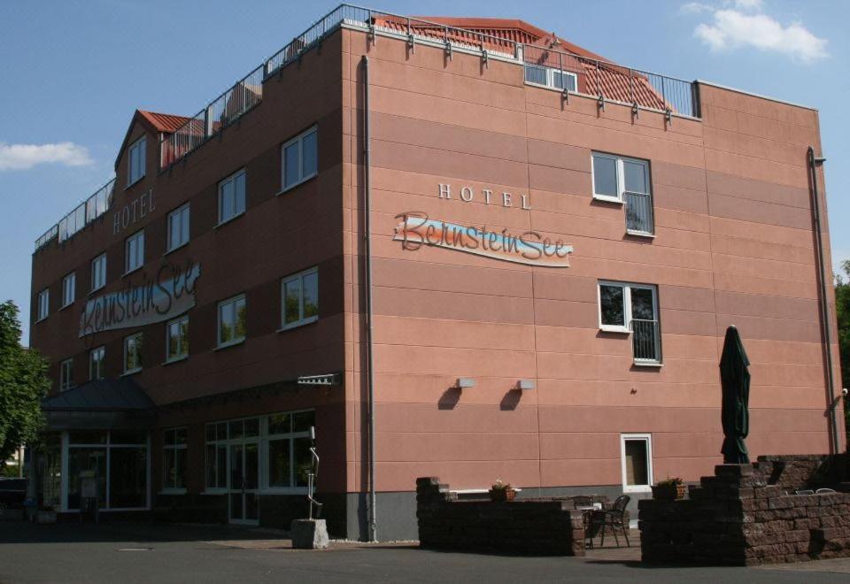 a building with a hotel sign on the side of it at Hotel BernsteinSee in Bitterfeld