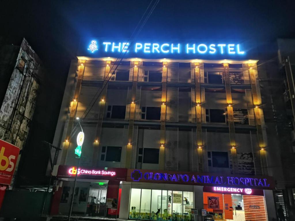 a building with a lit up sign on top of it at The Perch Hostel in Olongapo