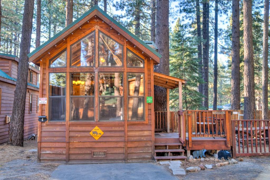 a small wooden cabin in the middle of a forest at Cabin - Full Kitchen - pet friendly - TV in South Lake Tahoe