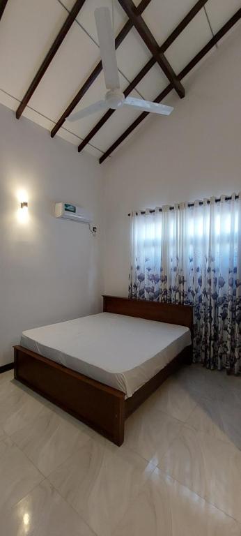 a bedroom with a large bed in a room at Negombo Villa in Negombo
