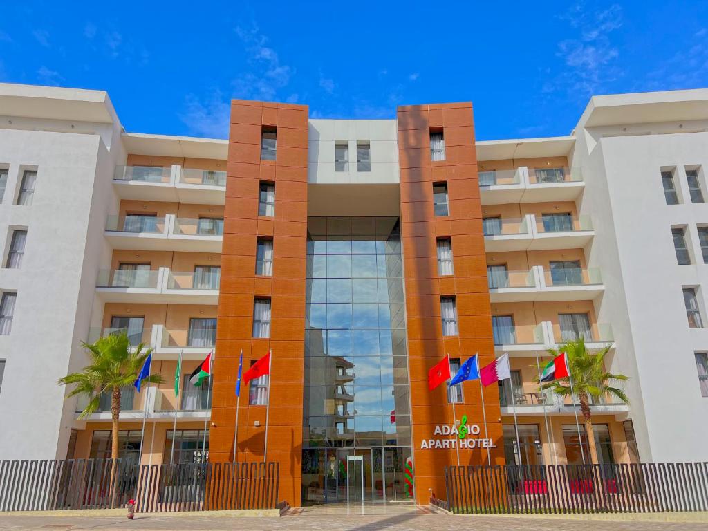 a building with flags in front of it at Great Holiday suites in Agadir